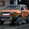 Mahindra Vision SXT pickup SUV concept front three-quarter view in matte black with pixel headlights