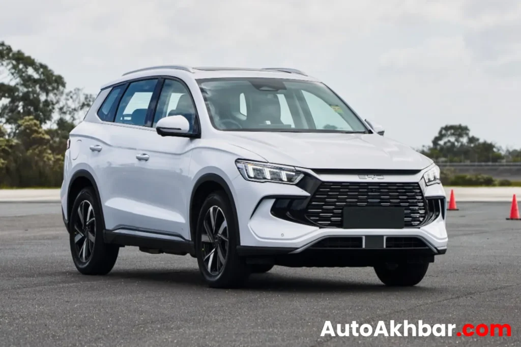Happy man surprised beside BYD Sealion 5 SUV with bold title graphics.