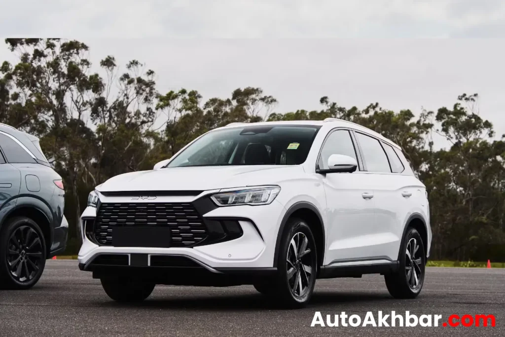 Happy man surprised beside BYD Sealion 5 SUV with bold title graphics.