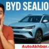 Happy man surprised beside BYD Sealion 5 SUV with bold title graphics.