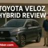 Toyota Veloz Hybrid 2025 with two people standing beside the car – AutoAkhbar.com branded featured image