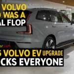 Rear view of upgraded 2026 Volvo EX90 electric SUV in a showroom with AutoAkhbar branding.