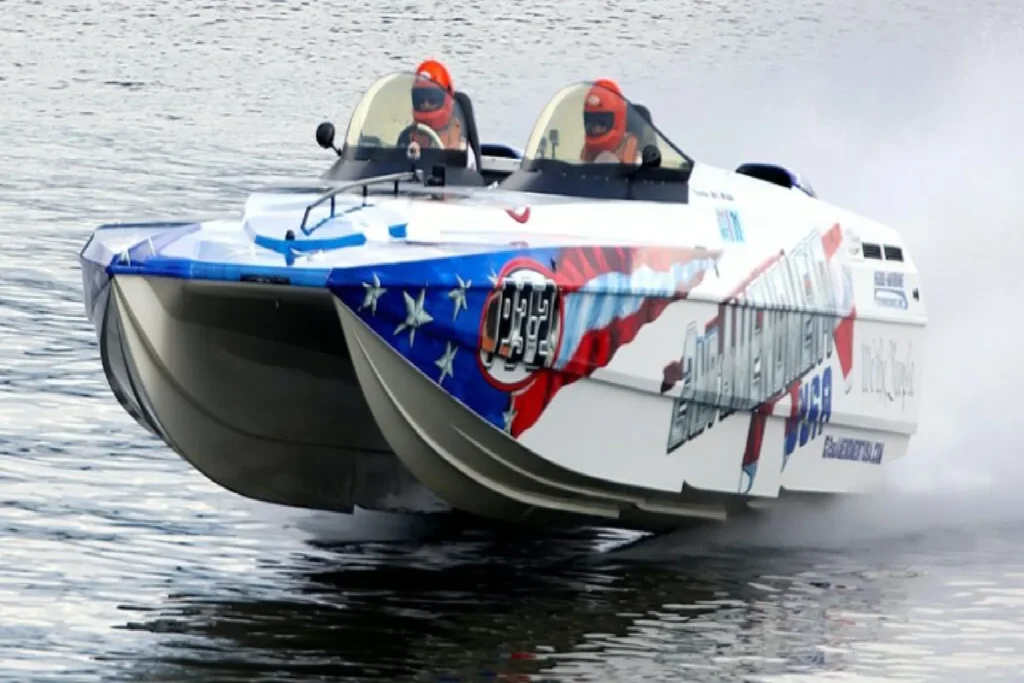 Jay Pilini died at 64, founder of Motion and Spectre Powerboats, pictured beside a high-performance powerboat