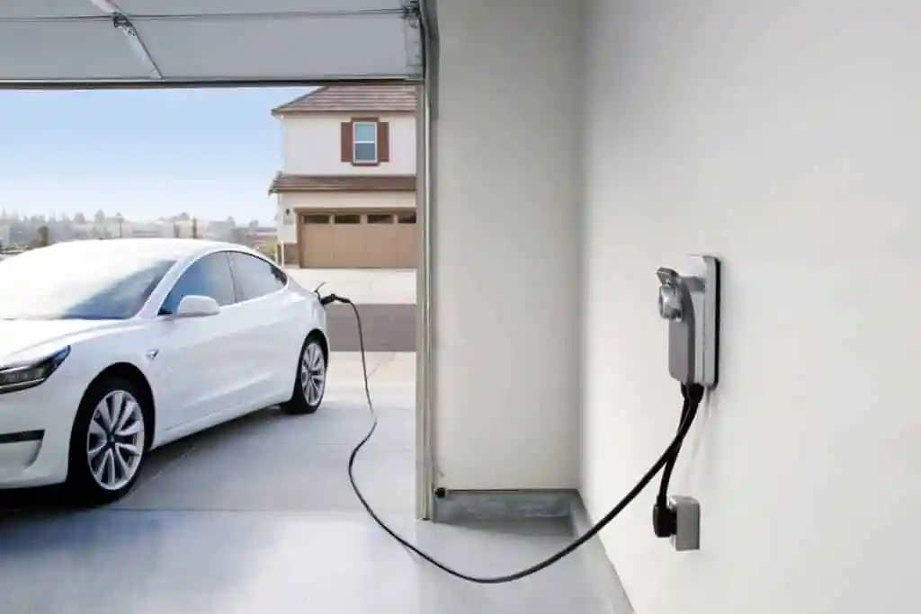 Tesla home charger installation in a modern garage showing Wall Connector setup