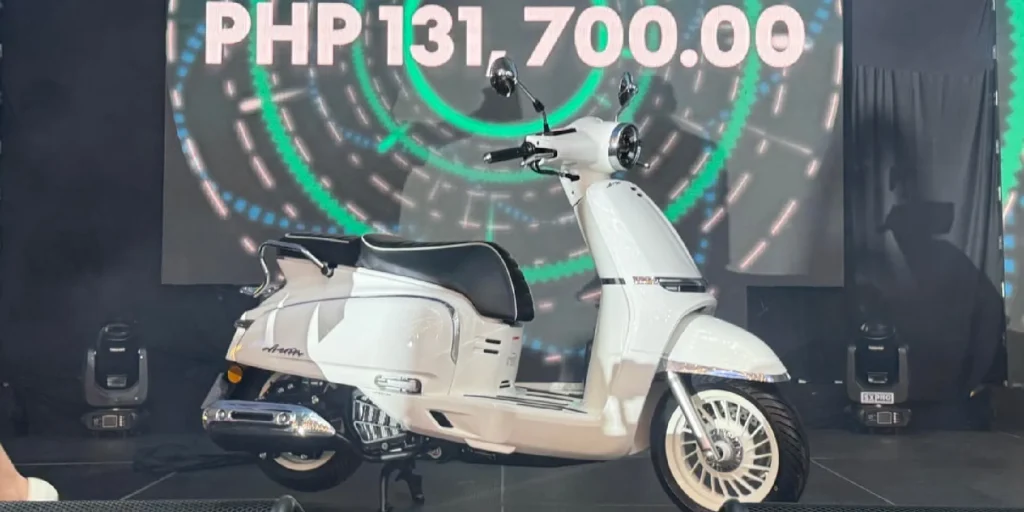 CFMOTO 150 Aura retro scooter displayed at launch event with model showcasing the scooter