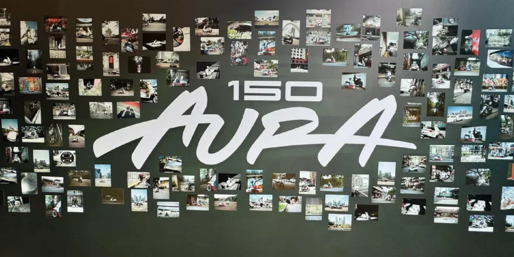 CFMOTO 150 Aura retro scooter displayed at launch event with model showcasing the scooter