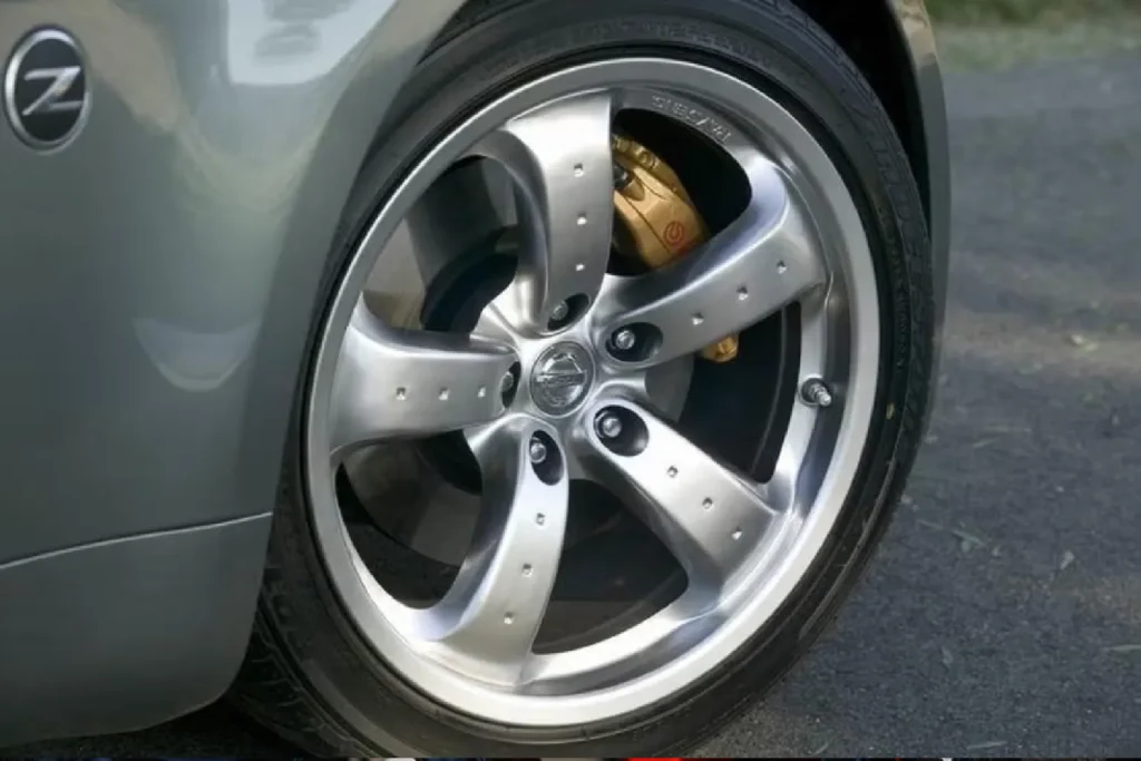 Close-up of a yellow brake caliper on a Nissan GT-R wheel Gold