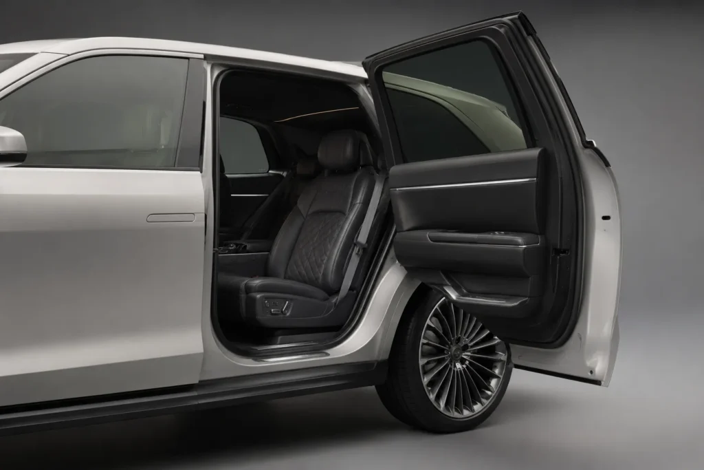 Rear-hinged coach door open on a luxury electric SUV showing no center pillar