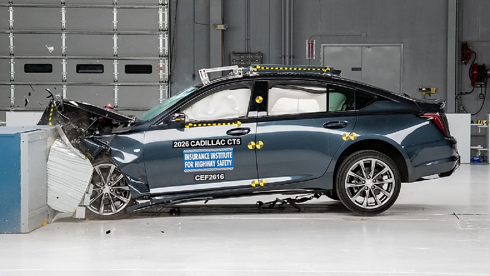 2026 Cadillac CT5 luxury sedan side profile in crash test facility