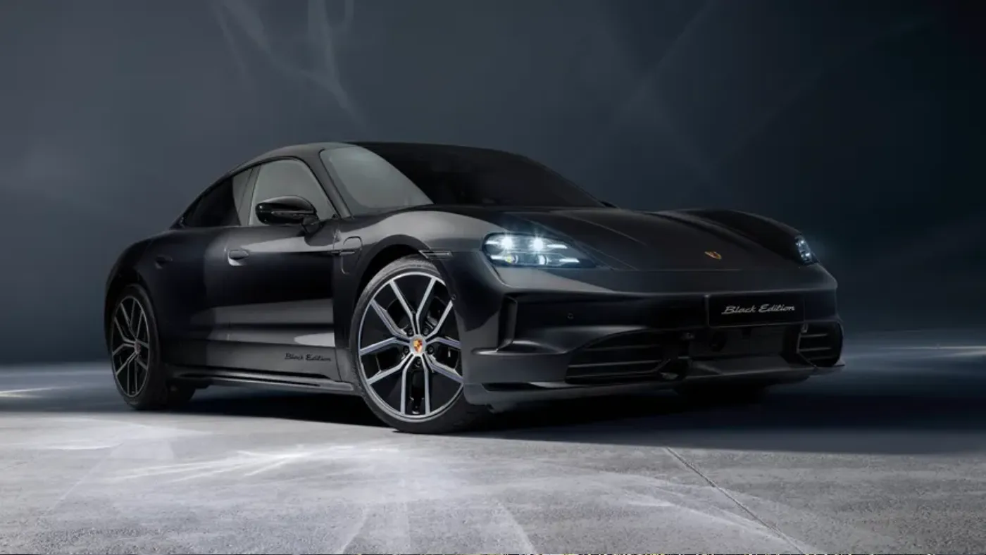 2026 Porsche Taycan 4 electric sedan on a city street at dusk, AutoAkhbar branded image