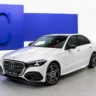 2027 Mercedes-Benz C-Class refreshed front three-quarter view with illuminated grille, AutoAkhbar branded image