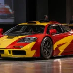 1996 McLaren F1 GTR race car displayed ahead of a classic car auction