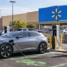 Walmart EV Charging Network : Electric vehicle charging at a fast-charging station in a retail store parking lot