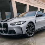 BMW 5 Series sedan being inspected by a technician for the driveshaft recall