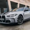 BMW 5 Series sedan being inspected by a technician for the driveshaft recall