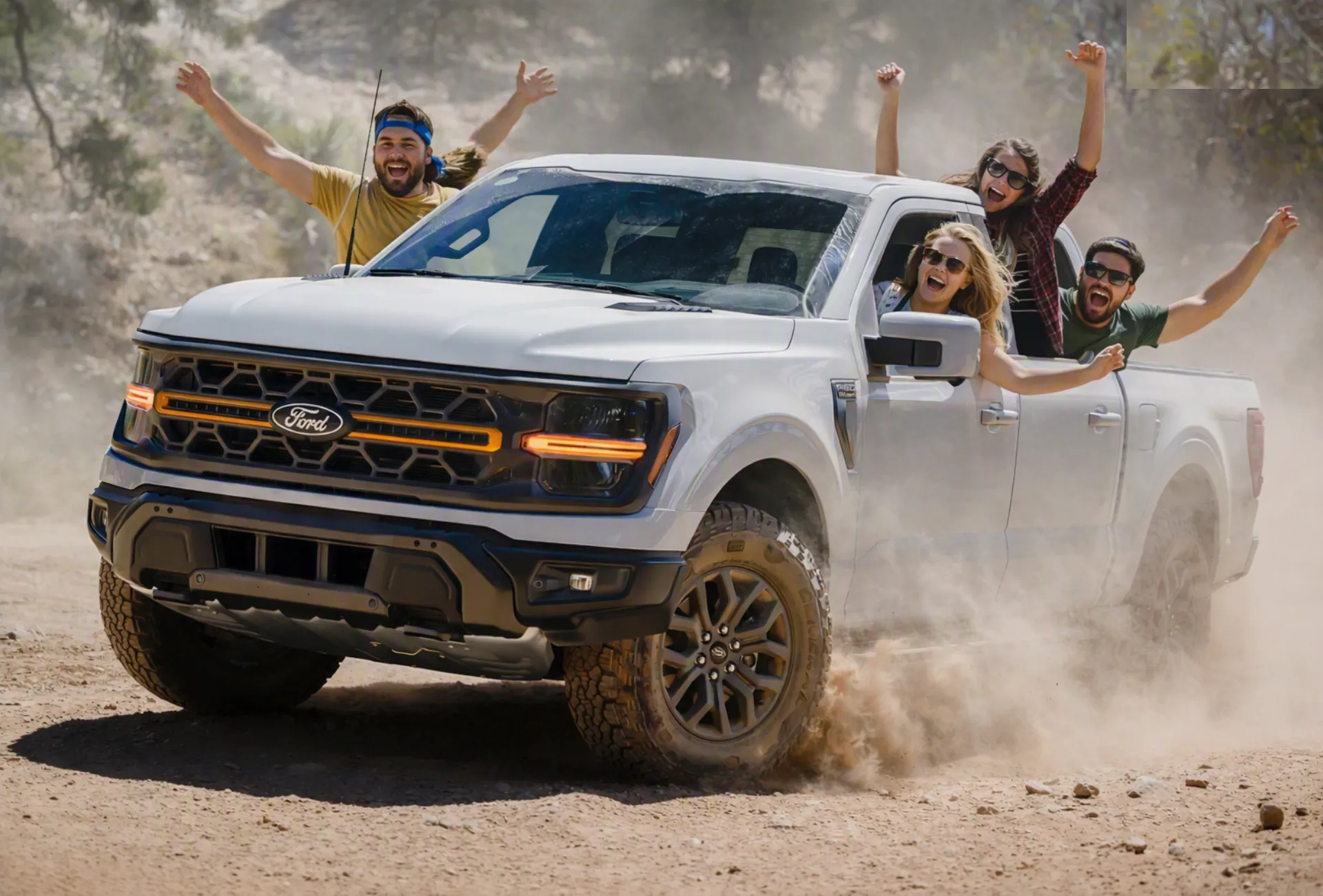Ford F-150 Raptor-style off-road pickup truck driving on a desert trail at sunset