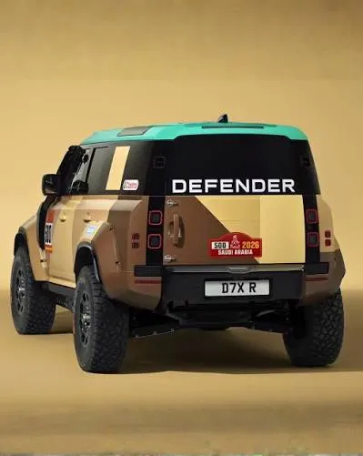Land Rover Defender Dakar SUV driving through desert dunes, AutoAkhbar branded image (2)