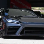 Toyota GR GT hybrid V8 supercar front three-quarter view, AutoAkhbar branded image