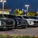 Row of Hyundai, Kia and Genesis SUVs parked at a dealership : Hyundai Kia