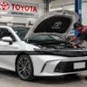 2026 Toyota Camry Hybrid exterior shot, AutoAkhbar.com branded image