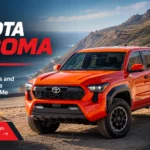 Red Toyota Tacoma 2026 pickup truck parked on a coastal road with mountains in the background, featuring price, specs, and trim options.