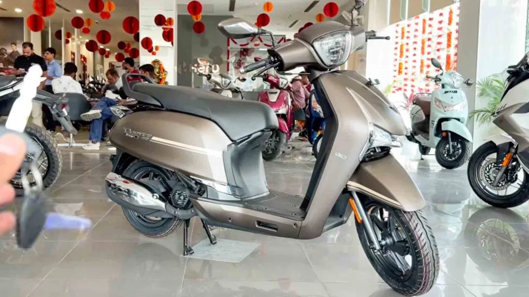 Front three-quarter view of the new Hero Destini 110 Classique Edition scooter in a premium bronze color scheme displayed inside a Hero MotoCorp dealership showroom.
