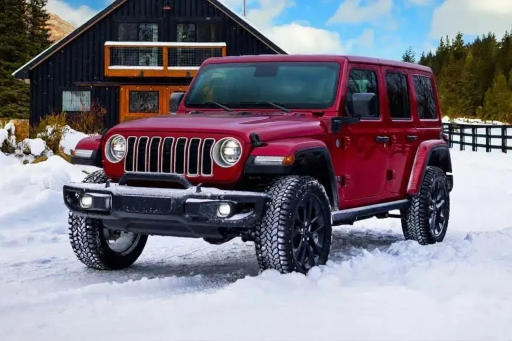 A red Jeep Wrangler style electric SUV Electric Jeep concept, the Jeep Recon, parked on a snowy road during a winter range test.